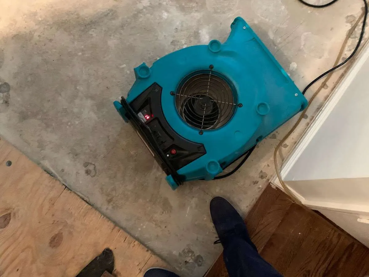 Air mover drying subfloor during Commercial Water Damage Restoration in Central Point